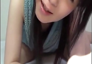 Japanese young cute girl malign with cucumber